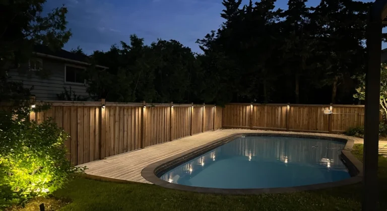 Summer outdoor lighting setup in a beautifully landscaped Toronto backyard, showing warm low voltage path and deck lights at dusk, ideal for homes across the GTA.
