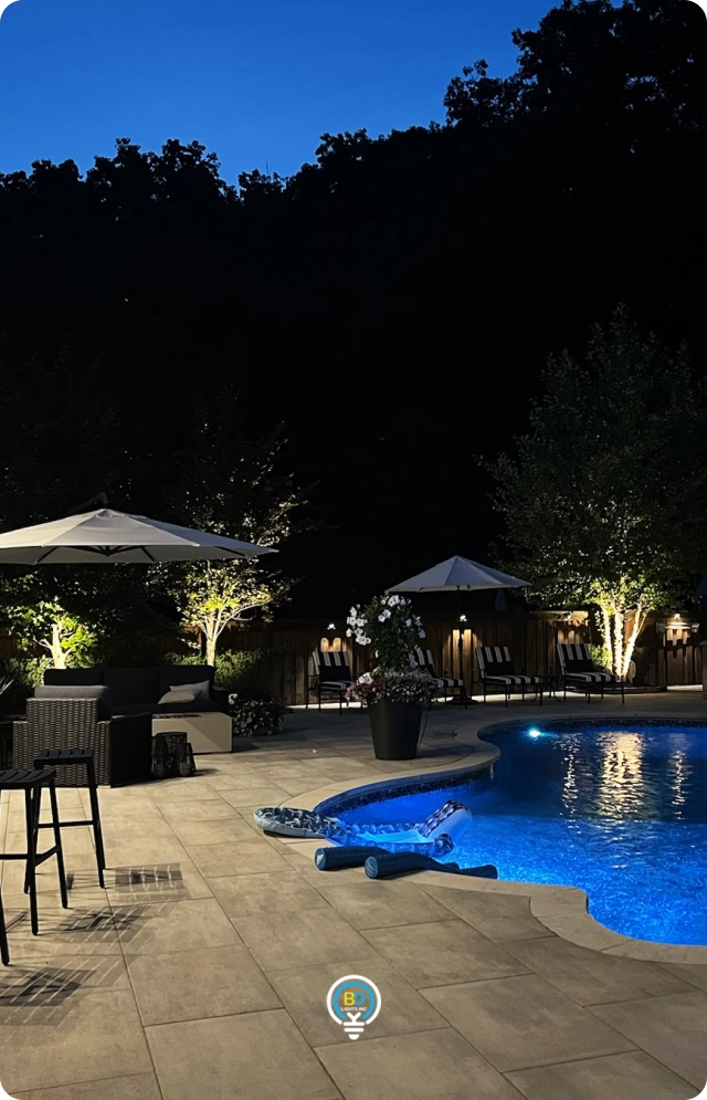 Backyard pool and landscape outdoor lighting installed at a Toronto home at night