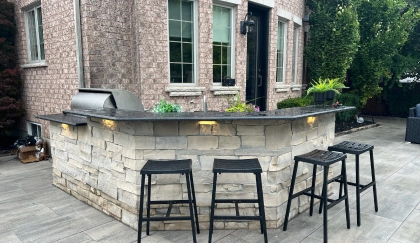 Hardscape patio lighting on curved stone seating wall and outdoor entertaining area at a Toronto property — BD Lights