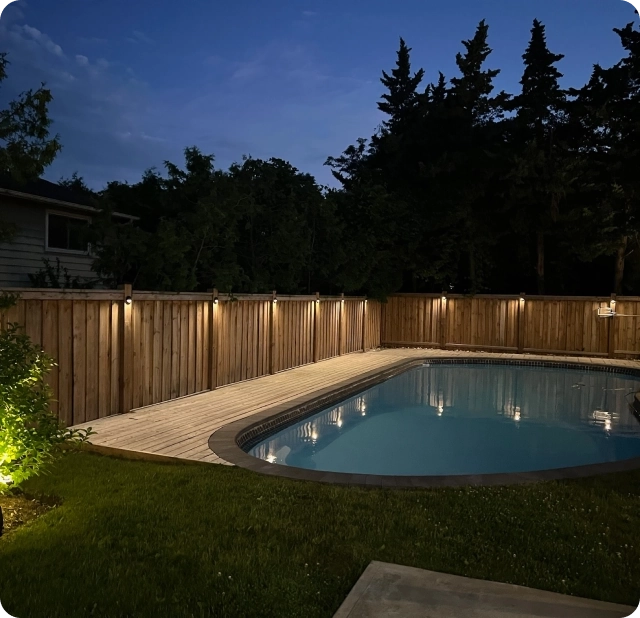 Low-voltage pool deck perimeter lighting and garden uplighting installed at a Toronto home at night — BD Lights